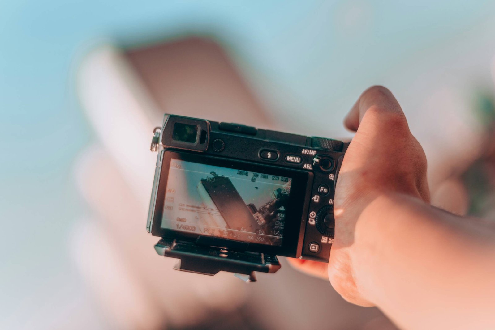 person pointing camera on high rise building